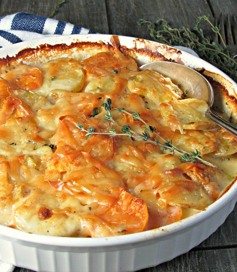 Yukon Gold Sweet Potato Au Gratin ~ thinly sliced sweet & Yukon gold potatoes topped with gruyere cheese + fresh thyme in a delicious creamy, silky sauce.