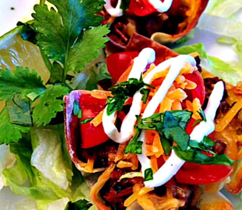 Taco Cupcakes: wontons filled with spicy ground beef topped with cheese, lettuce, tomatoes and everything you love on a taco all baked in mini muffin tins.