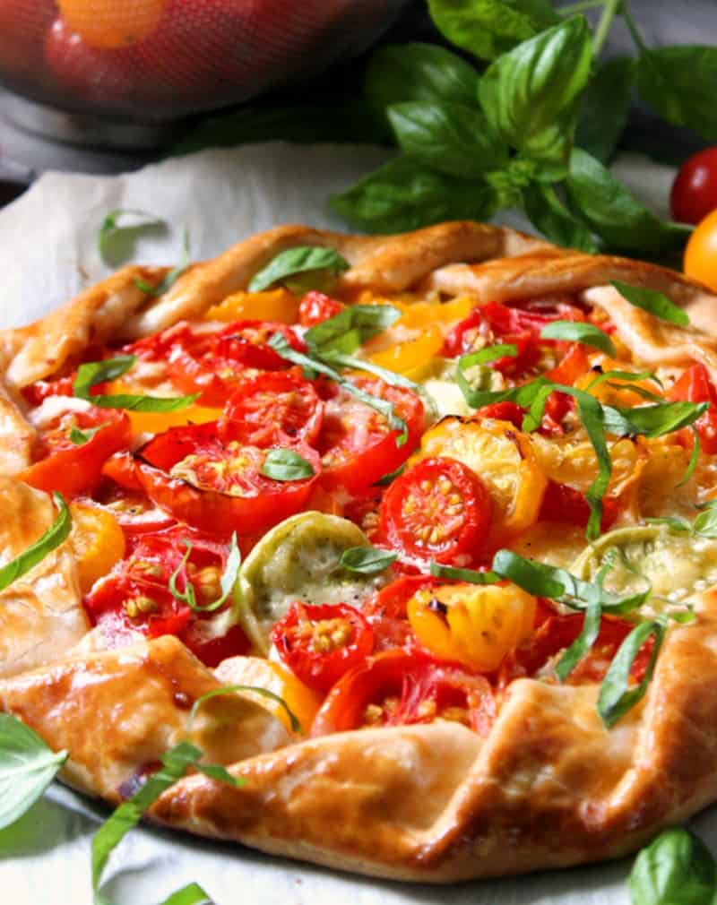 whole tomato galette garnished with sliced basil.