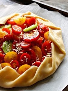 Tomato Galette ~ sweet summer tomatoes baked with tangy goat cheese, fresh basil and thyme wrapped in a buttery, flaky crust.