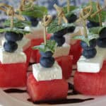 white plate with watermelon feta blueberry bites