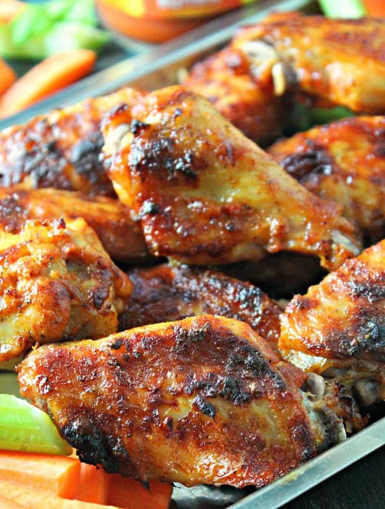 platter of baked chicken wings brushed with buffalo sauce
